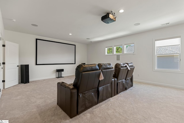 home theater with visible vents, light colored carpet, and baseboards