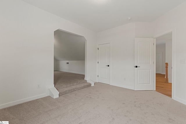 bonus room with carpet flooring, baseboards, and stairs