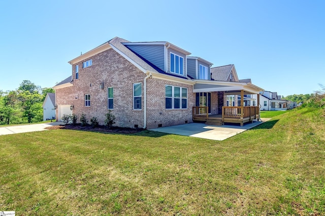 back of property featuring brick siding, a lawn, crawl space, and a patio area