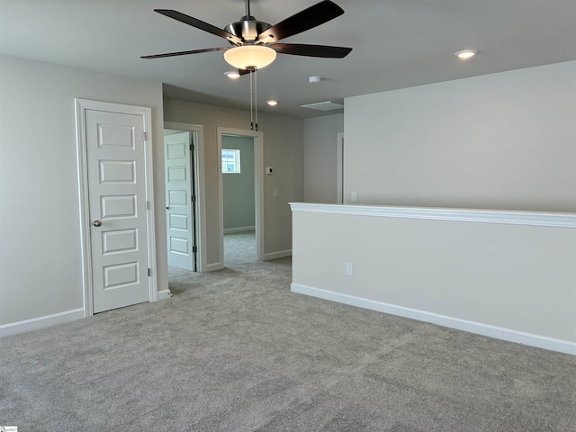 unfurnished room featuring visible vents, ceiling fan, baseboards, and carpet