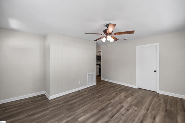 unfurnished room featuring visible vents, ceiling fan, wood finished floors, and baseboards