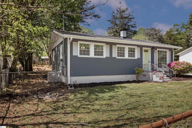 view of front of home featuring roof with shingles, a chimney, crawl space, a front yard, and fence