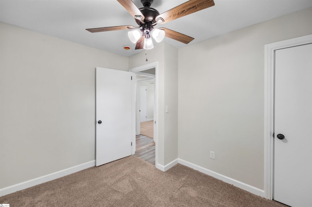 unfurnished bedroom with baseboards, ceiling fan, and carpet