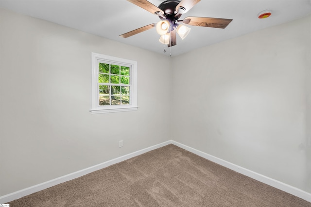 unfurnished room with ceiling fan, baseboards, and carpet