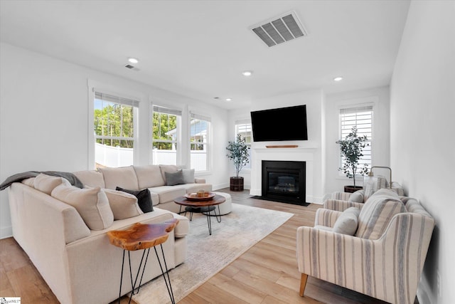 102 Moorish Cir, Simpsonville, SC 29681 - living room featuring recessed lighting, a fireplace with flush hearth, visible vents, and light wood-type flooring