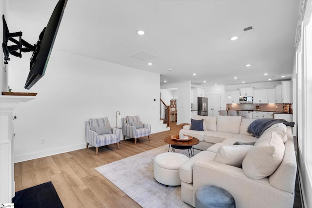 102 Moorish Cir, Simpsonville, SC 29681 - living area featuring light wood-type flooring, baseboards, recessed lighting, stairway, and visible vents
