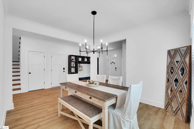 102 Moorish Cir, Simpsonville, SC 29681 - dining area featuring a chandelier, light wood-style floors, baseboards, and ornamental molding