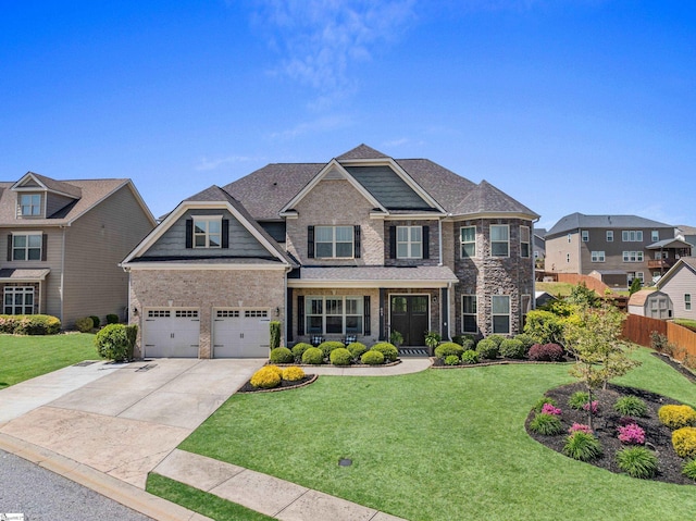 craftsman inspired home featuring fence, brick siding, a front yard, and concrete driveway