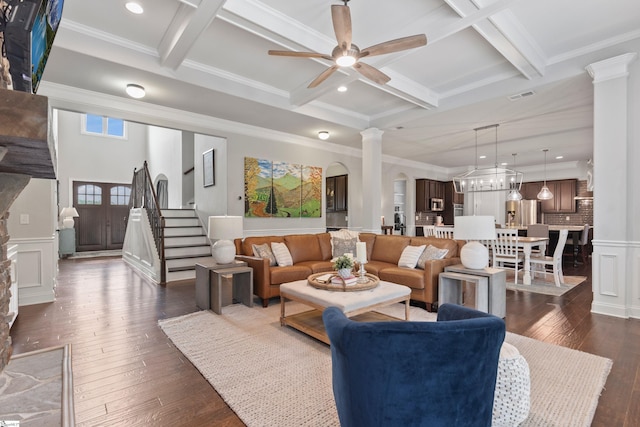 living room with ornate columns, coffered ceiling, beamed ceiling, ceiling fan, and dark wood-type flooring