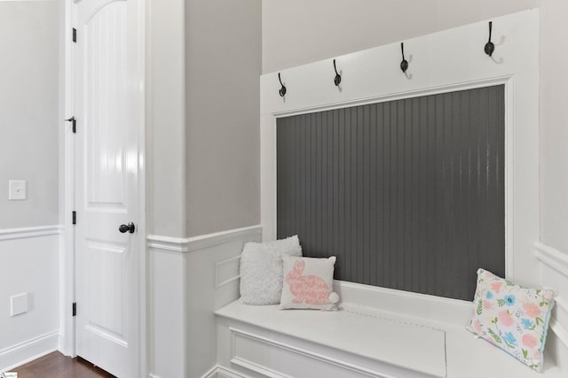 mudroom featuring baseboards and dark wood-style floors