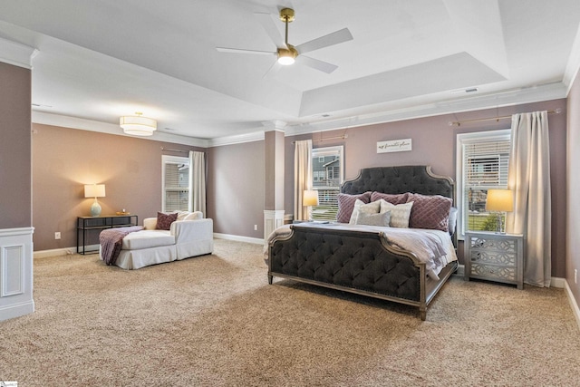 carpeted bedroom with crown molding, multiple windows, and a raised ceiling
