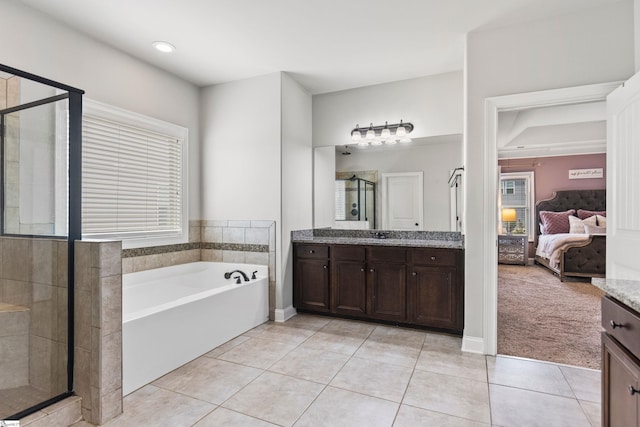 ensuite bathroom featuring vanity, a stall shower, tile patterned flooring, a garden tub, and ensuite bath