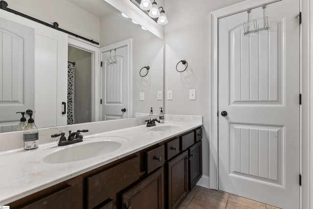 full bathroom featuring tile patterned flooring, a sink, and double vanity
