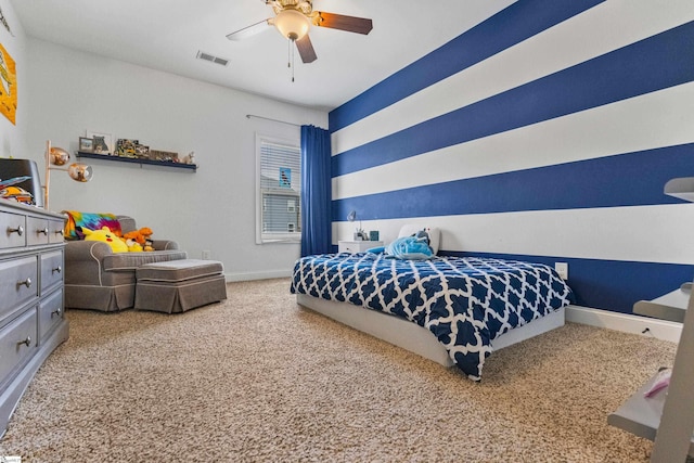 carpeted bedroom with baseboards, a ceiling fan, and visible vents