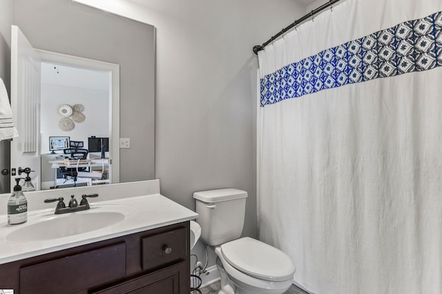 bathroom with vanity, curtained shower, and toilet