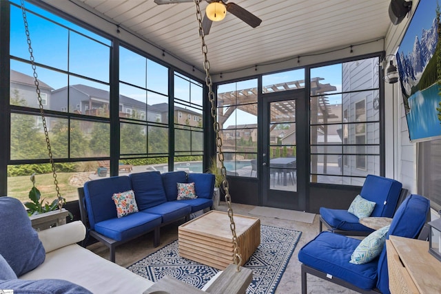 sunroom / solarium featuring ceiling fan and outdoor lounge area