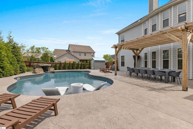 view of pool featuring a pergola, a fenced backyard, a patio area, an outdoor structure, and a storage unit