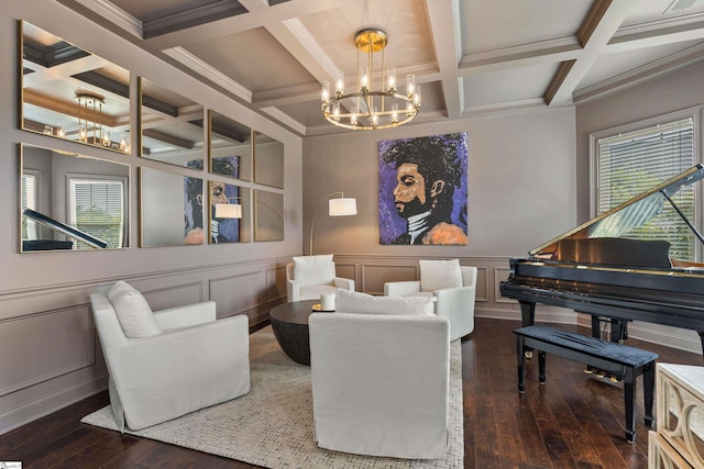 sitting room with hardwood / wood-style floors, coffered ceiling, beamed ceiling, a decorative wall, and a chandelier
