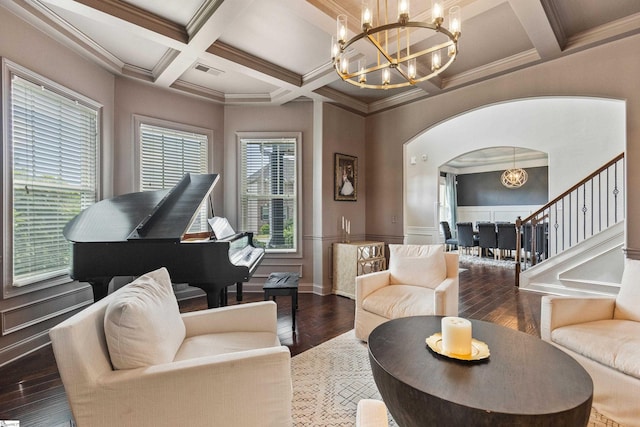 living area with coffered ceiling, wood finished floors, visible vents, arched walkways, and a chandelier