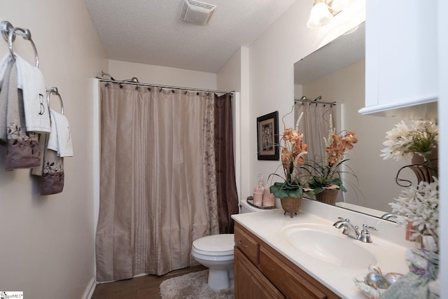 38 River Park Ln, Taylors, SC 29687 - bathroom featuring wood finished floors, visible vents, toilet, vanity, and a textured ceiling