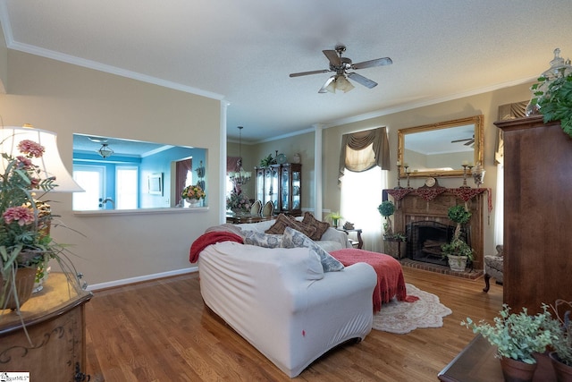 38 River Park Ln, Taylors, SC 29687 - living area featuring a ceiling fan, wood finished floors, a fireplace, baseboards, and ornamental molding