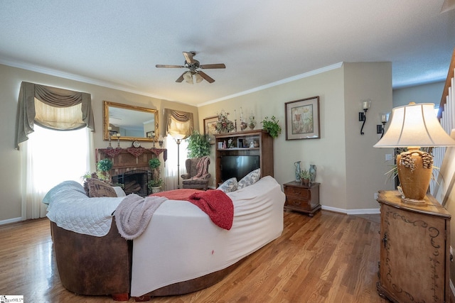 38 River Park Ln, Taylors, SC 29687 - living room with a ceiling fan, wood finished floors, a fireplace, baseboards, and ornamental molding