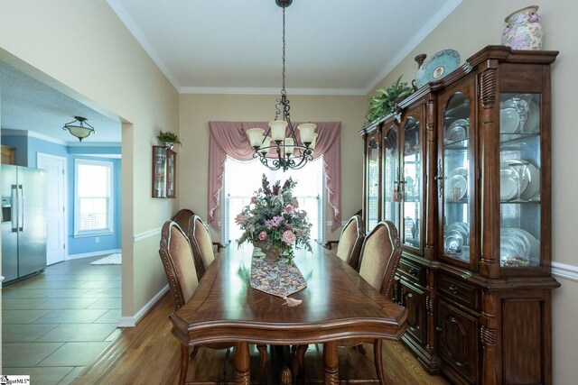 38 River Park Ln, Taylors, SC 29687 - dining room with baseboards, wood finished floors, an inviting chandelier, and crown molding