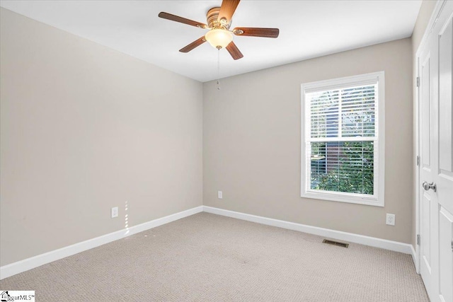 unfurnished bedroom featuring ceiling fan, light carpet, visible vents, and baseboards