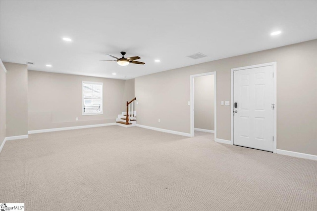 below grade area with light colored carpet, baseboards, a ceiling fan, and recessed lighting