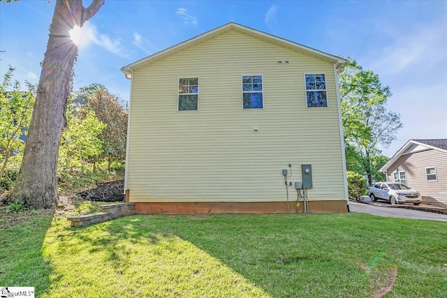view of side of property with a lawn