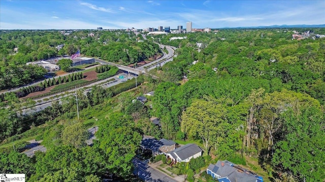 birds eye view of property with a view of trees