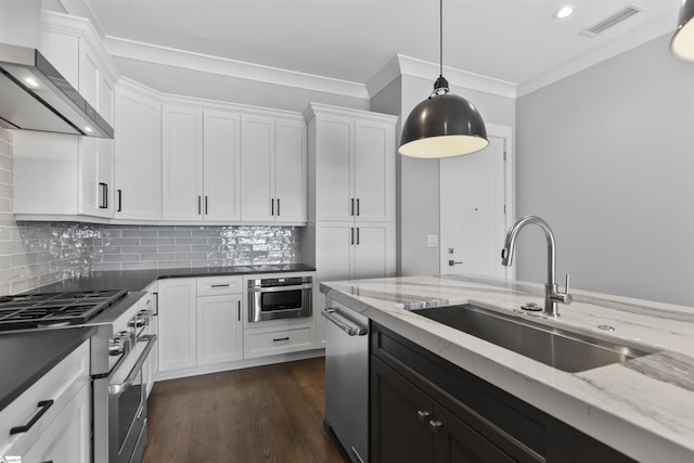 110 N Markley St Unit 304, Greenville, SC 29601 - kitchen with a sink, appliances with stainless steel finishes, wall chimney exhaust hood, white cabinetry, and visible vents