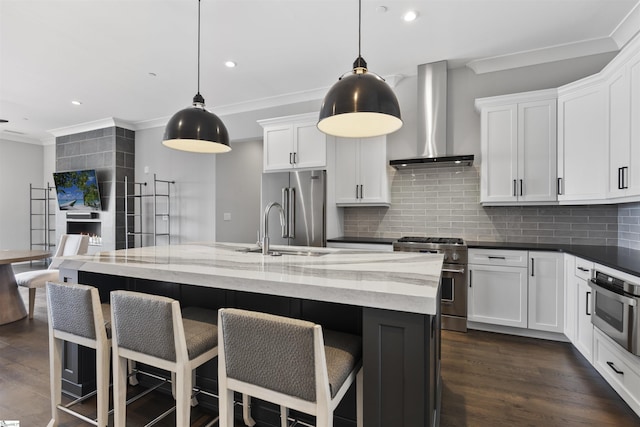 110 N Markley St Unit 304, Greenville, SC 29601 - kitchen with backsplash, high quality appliances, ornamental molding, and wall chimney range hood