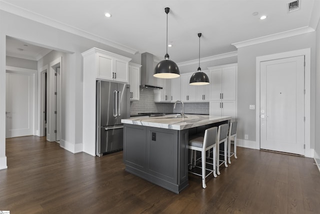 110 N Markley St Unit 304, Greenville, SC 29601 - kitchen featuring wall chimney exhaust hood, white cabinets, high quality fridge, visible vents, and decorative backsplash