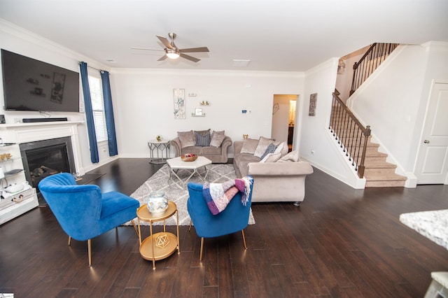 living area with baseboards, a ceiling fan, stairway, ornamental molding, and wood-type flooring