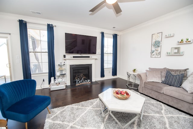 living area with ceiling fan, wood finished floors, and ornamental molding