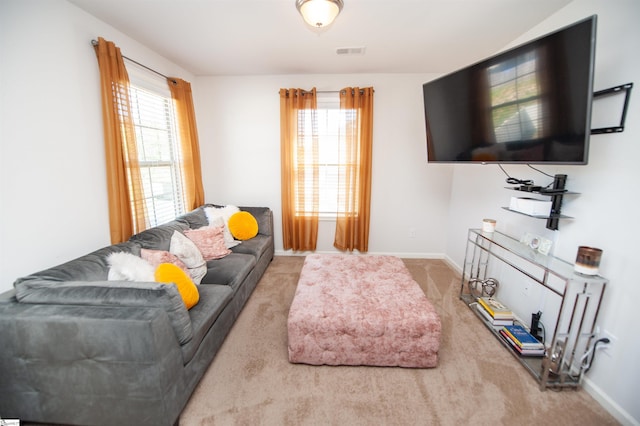 carpeted living room featuring baseboards and visible vents