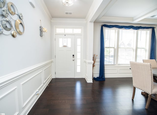 entrance foyer featuring ornamental molding, a decorative wall, dark wood-style flooring, and visible vents