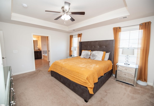 bedroom with visible vents, ornamental molding, and a tray ceiling