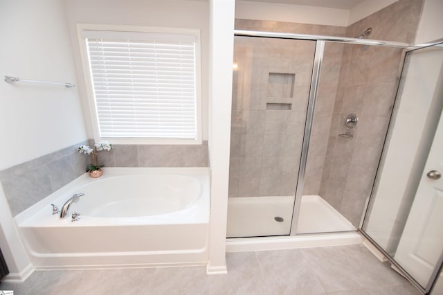 full bath featuring a shower stall, a garden tub, and tile patterned flooring