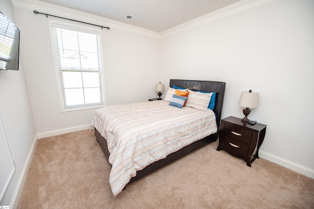 bedroom with light colored carpet, baseboards, crown molding, and visible vents