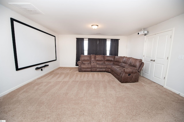 cinema room featuring baseboards, carpet flooring, and visible vents