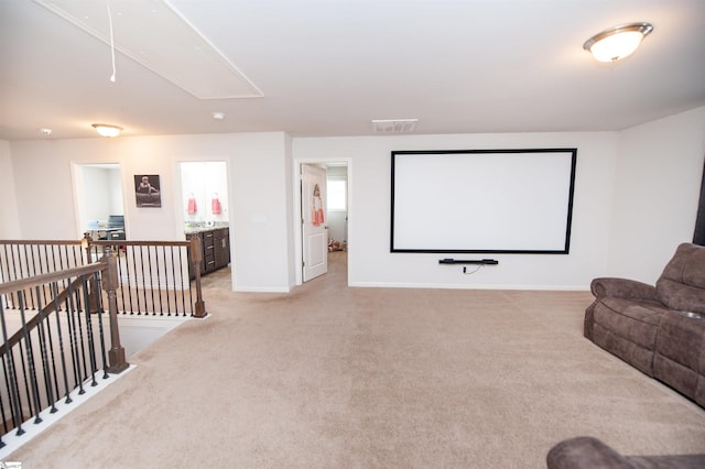 cinema featuring light colored carpet, baseboards, and visible vents