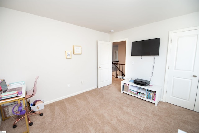 carpeted office featuring baseboards