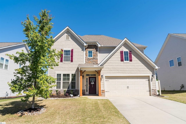 view of front of house with a front lawn, driveway, stone siding, and an attached garage