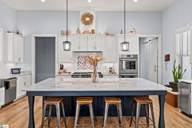 1359 Martin Creek Rd, Seneca, SC 29678 - kitchen with decorative backsplash, white cabinetry, stainless steel appliances, and light wood-style flooring