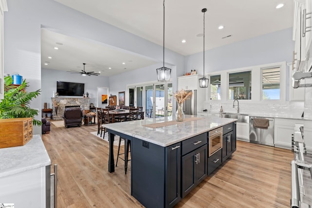 1359 Martin Creek Rd, Seneca, SC 29678 - kitchen with white cabinetry, a sink, a fireplace, appliances with stainless steel finishes, and ceiling fan