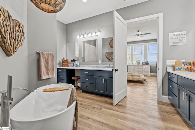 1359 Martin Creek Rd, Seneca, SC 29678 - ensuite bathroom featuring two vanities, a sink, a ceiling fan, a freestanding tub, and wood finished floors