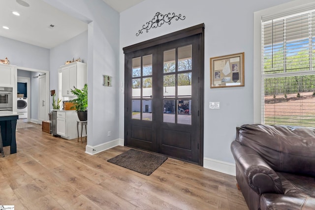 1359 Martin Creek Rd, Seneca, SC 29678 - entryway featuring a wealth of natural light, washer / dryer, light wood-style floors, and baseboards