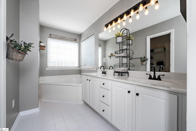 full bathroom featuring tile patterned flooring, a garden tub, a sink, and double vanity